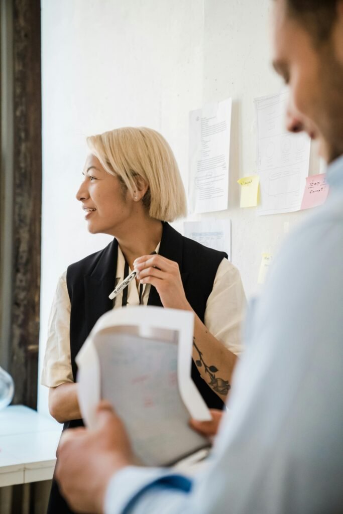 Professional office setting with colleagues discussing ideas during a casual meeting.